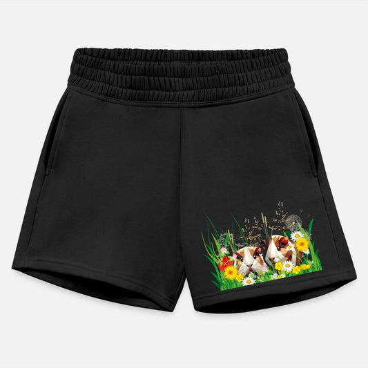 Two guinea pigs in the magic of a flower meadow